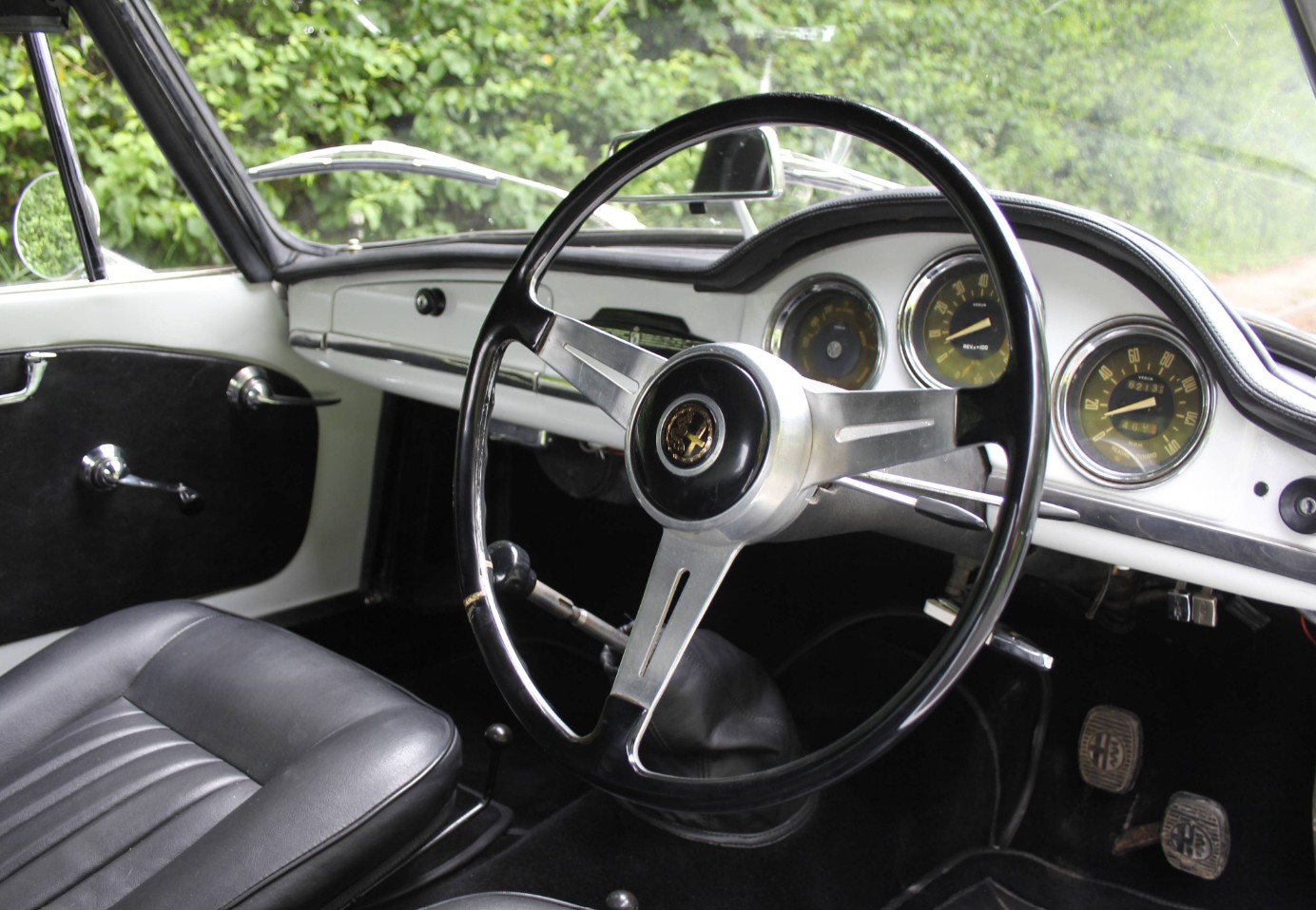 The right-hand-drive cabin of RCA 379B, with black trim, Veglia instruments and a three-spoke steering wheel